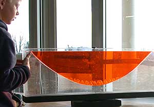 A fluid assuming a parabolic shape as it is rotating